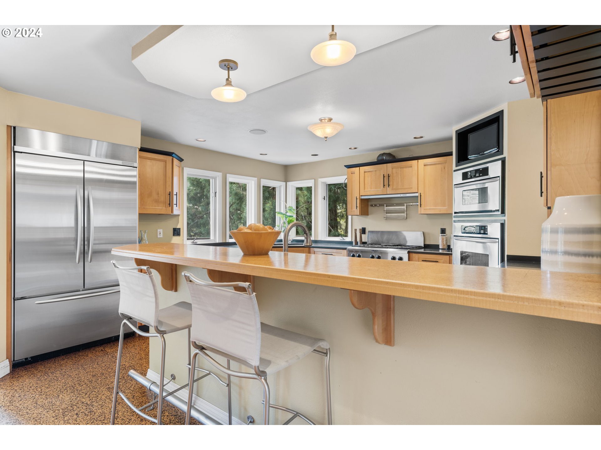 4803 Southwest Stonebrook Court Portland, OR 97239 - Photo 12 of 40 a kitchen with stainless steel appliances granite countertop a sink and refrigerator