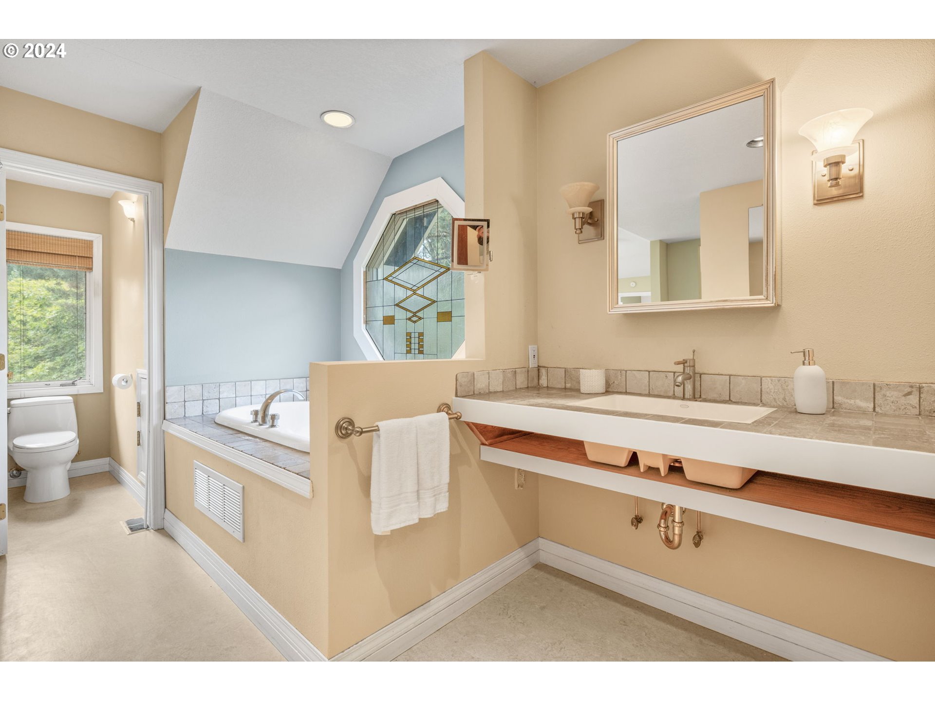4803 Southwest Stonebrook Court Portland, OR 97239 - Photo 25 of 40 a bathroom with a sink and a mirror