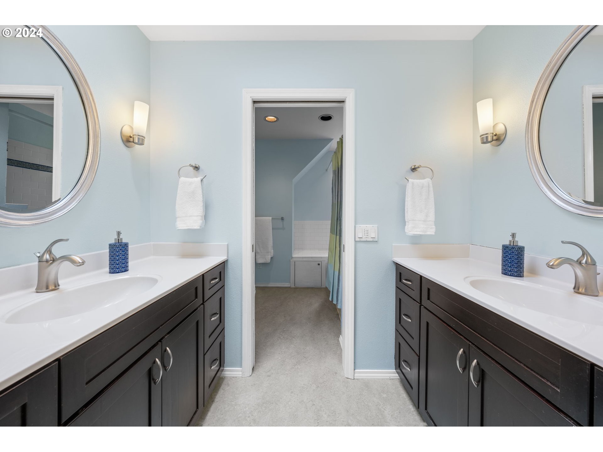 4803 Southwest Stonebrook Court Portland, OR 97239 - Photo 29 of 40 a en suite bathroom with a double vanity sink and a mirror