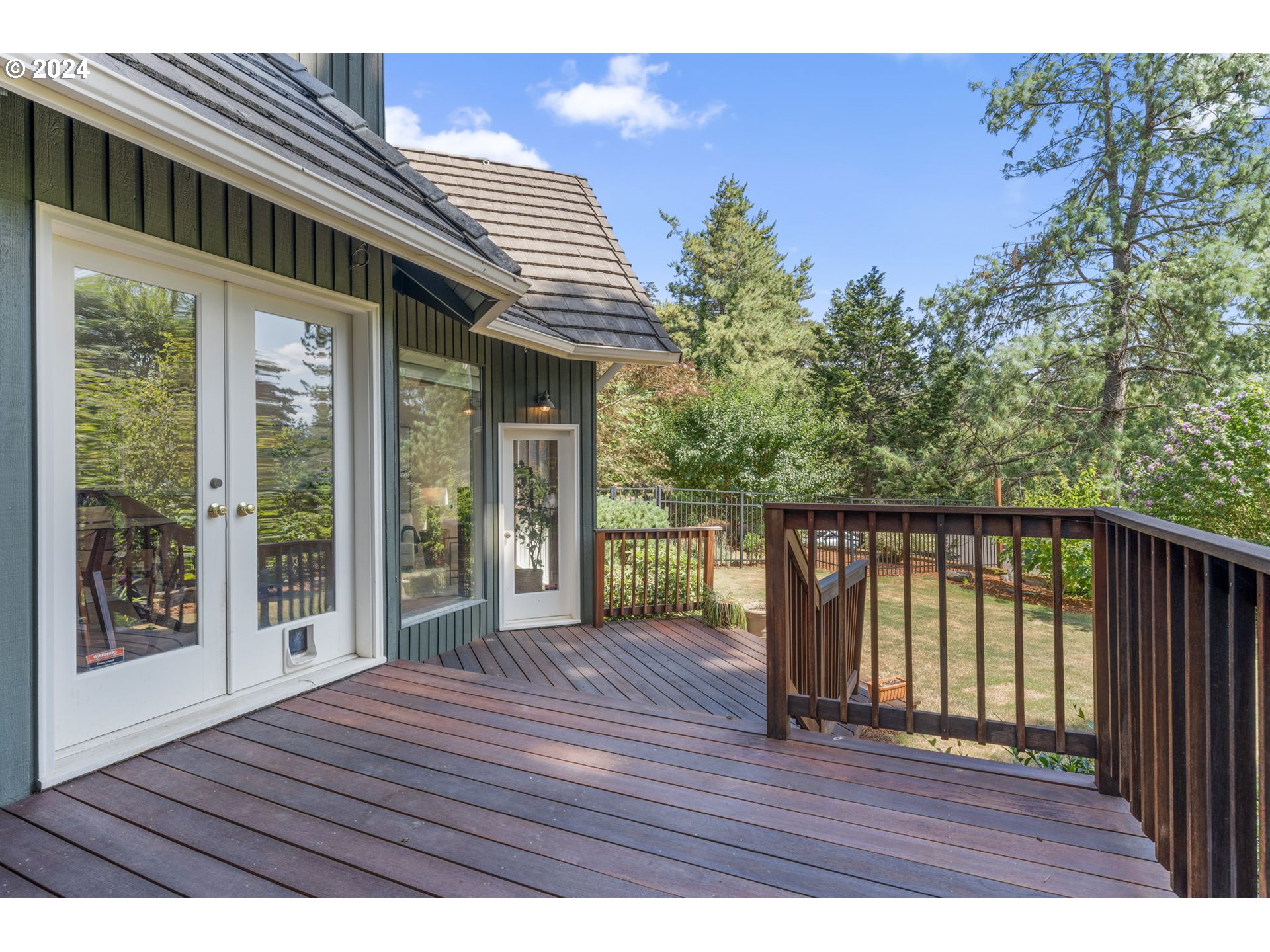 4803 Southwest Stonebrook Court Portland, OR 97239 - Photo 31 of 40 a view of backyard with wooden floor and floor to ceiling window
