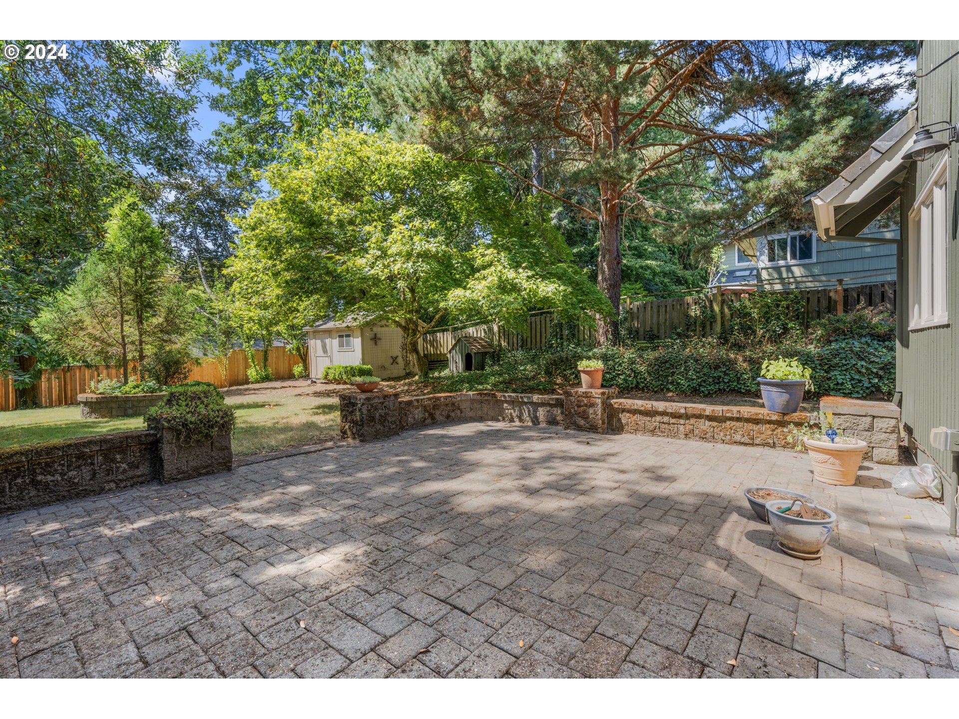 4803 Southwest Stonebrook Court Portland, OR 97239 - Photo 33 of 40 a row of palm trees and a fire pit with large trees