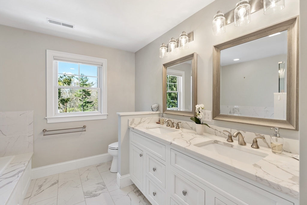 24 Pine Knoll Road Lexington, MA 02420 - Photo 21 of 41 a bathroom with a granite countertop sink mirror and a bathtub