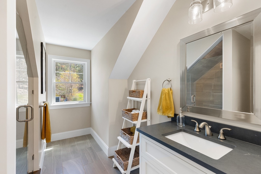 24 Pine Knoll Road Lexington, MA 02420 - Photo 30 of 41 a bathroom with a granite countertop sink and a mirror