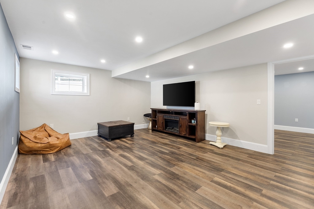 24 Pine Knoll Road Lexington, MA 02420 - Photo 32 of 41 a living room with furniture and a flat screen tv