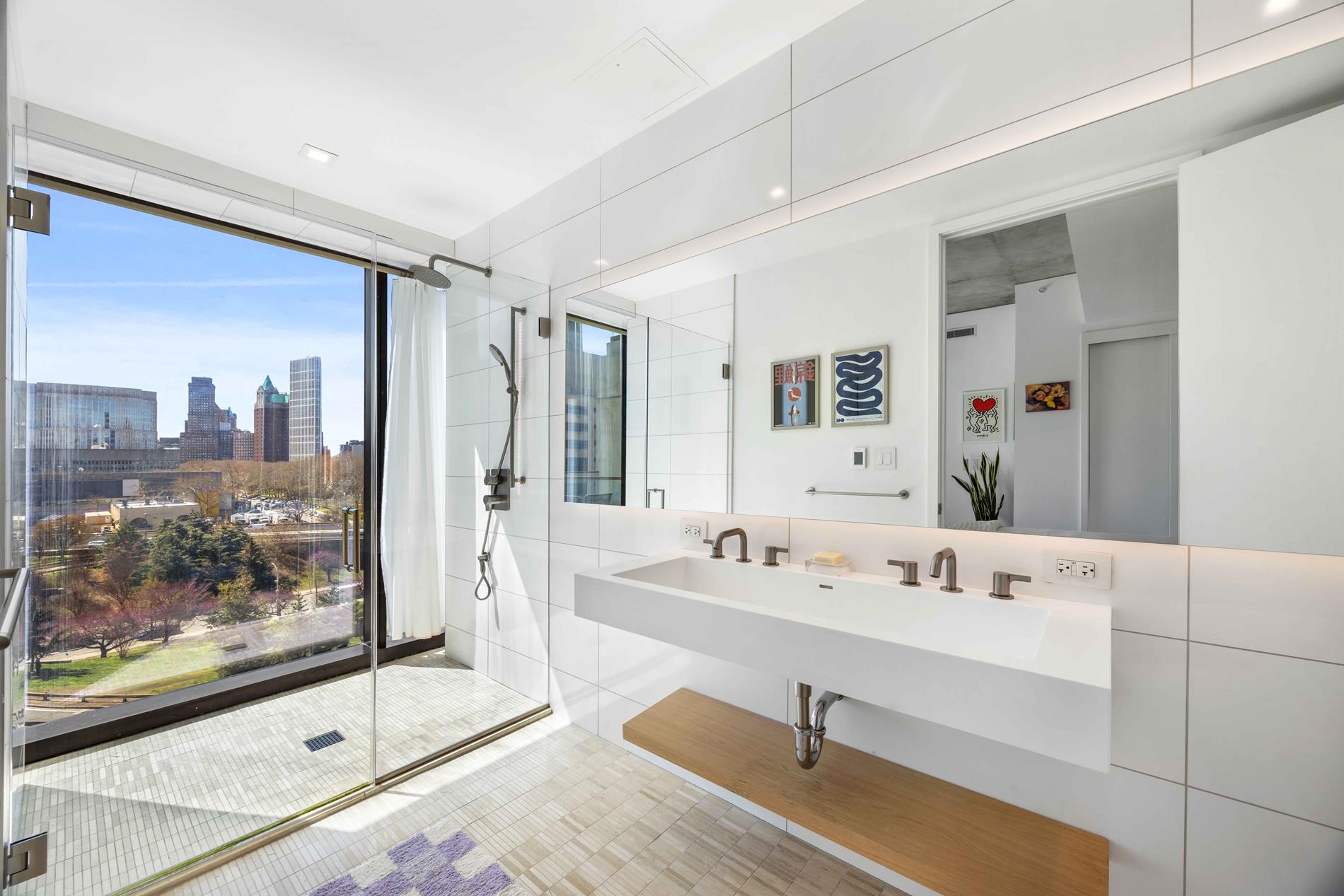 98 Front Street, Unit PH3E Brooklyn, NY 11201 - Photo 6 of 16 a spacious bathroom with a double vanity sink and a mirror