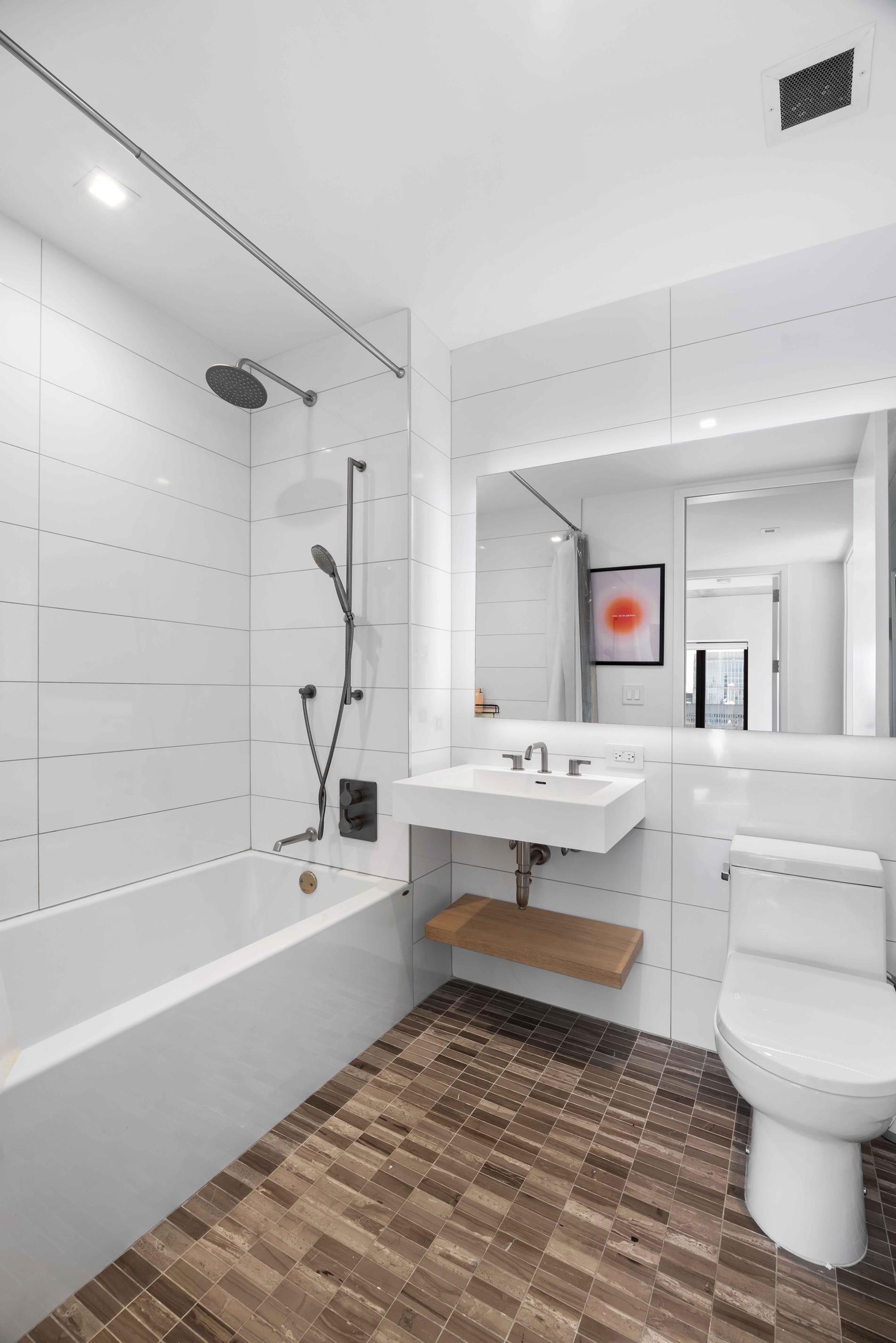 98 Front Street, Unit PH3E Brooklyn, NY 11201 - Photo 8 of 16 a bathroom with a sink a toilet and a bathtub
