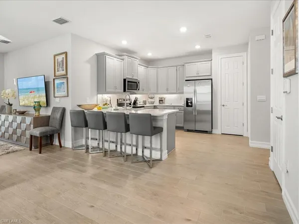 a kitchen with a sink cabinets and wooden floor