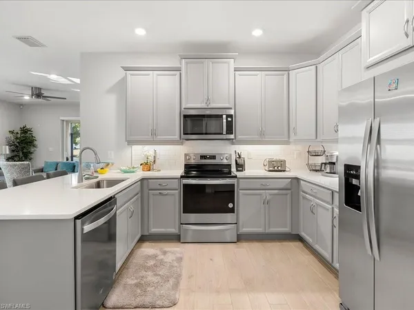 a kitchen with cabinets a sink a counter space stainless steel appliances and cabinets