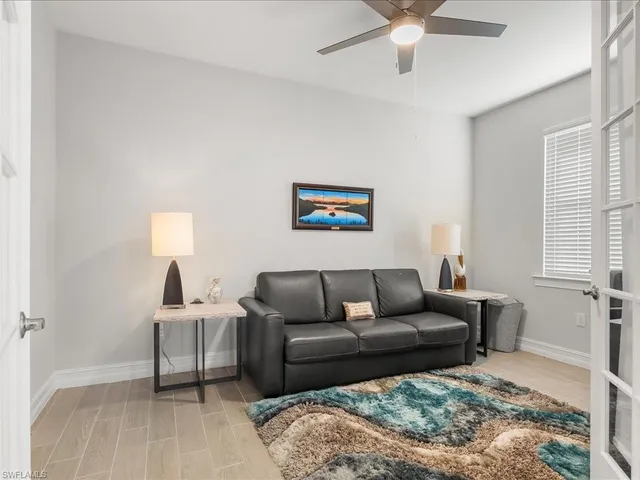 a view of a livingroom with furniture and a window