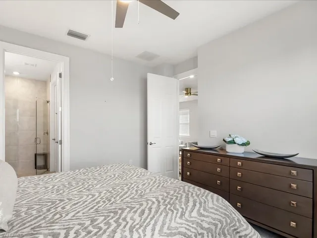 a bathroom with a double vanity sink mirror and shower