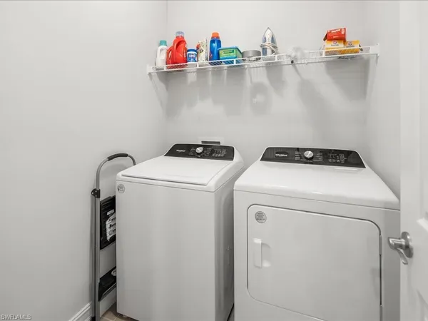 a view of a house with pool and a chairs