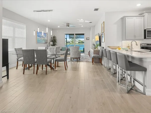 a dining room with furniture a rug and wooden floor