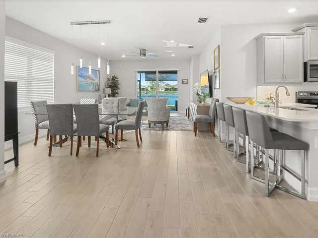 a dining room with furniture a rug and wooden floor