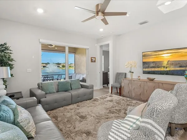 a living room with furniture and a large window