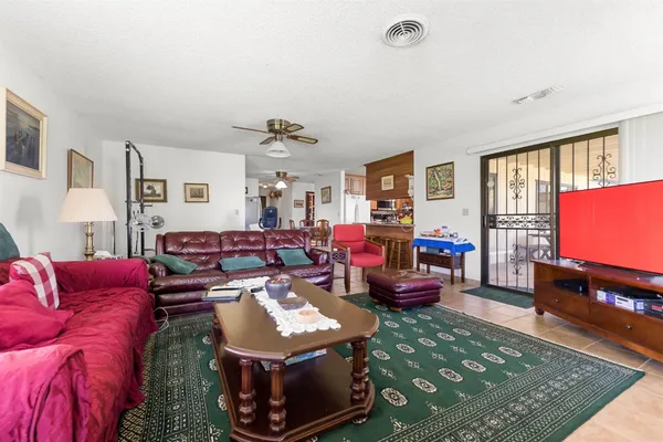 a living room with furniture a rug and a flat screen tv