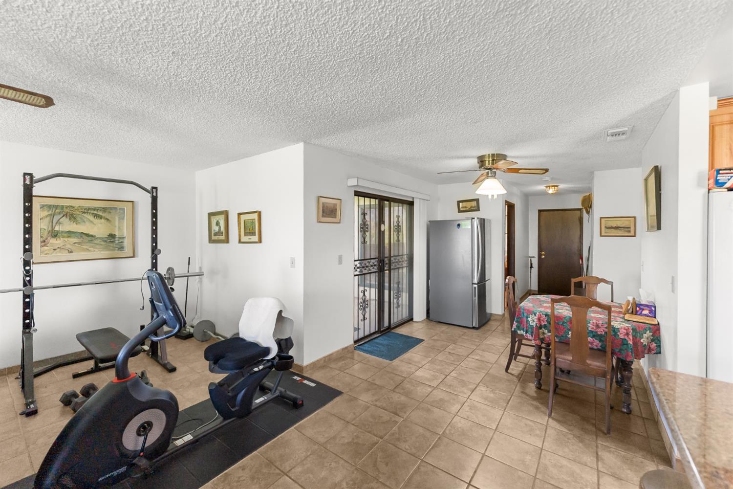 4776 Stetson Road Clovis, CA 93619 - Photo 20 of 49 a room with furniture a window and gym equipment