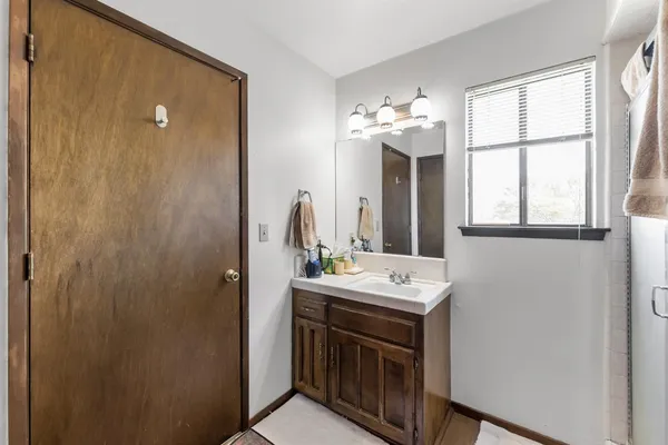a bathroom with a sink a toilet and a mirror