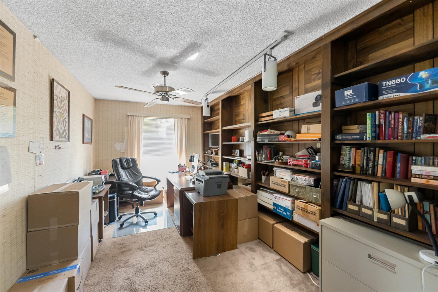 4776 Stetson Road Clovis, CA 93619 - Photo 25 of 49 a view of a workspace with furniture and a book shelf