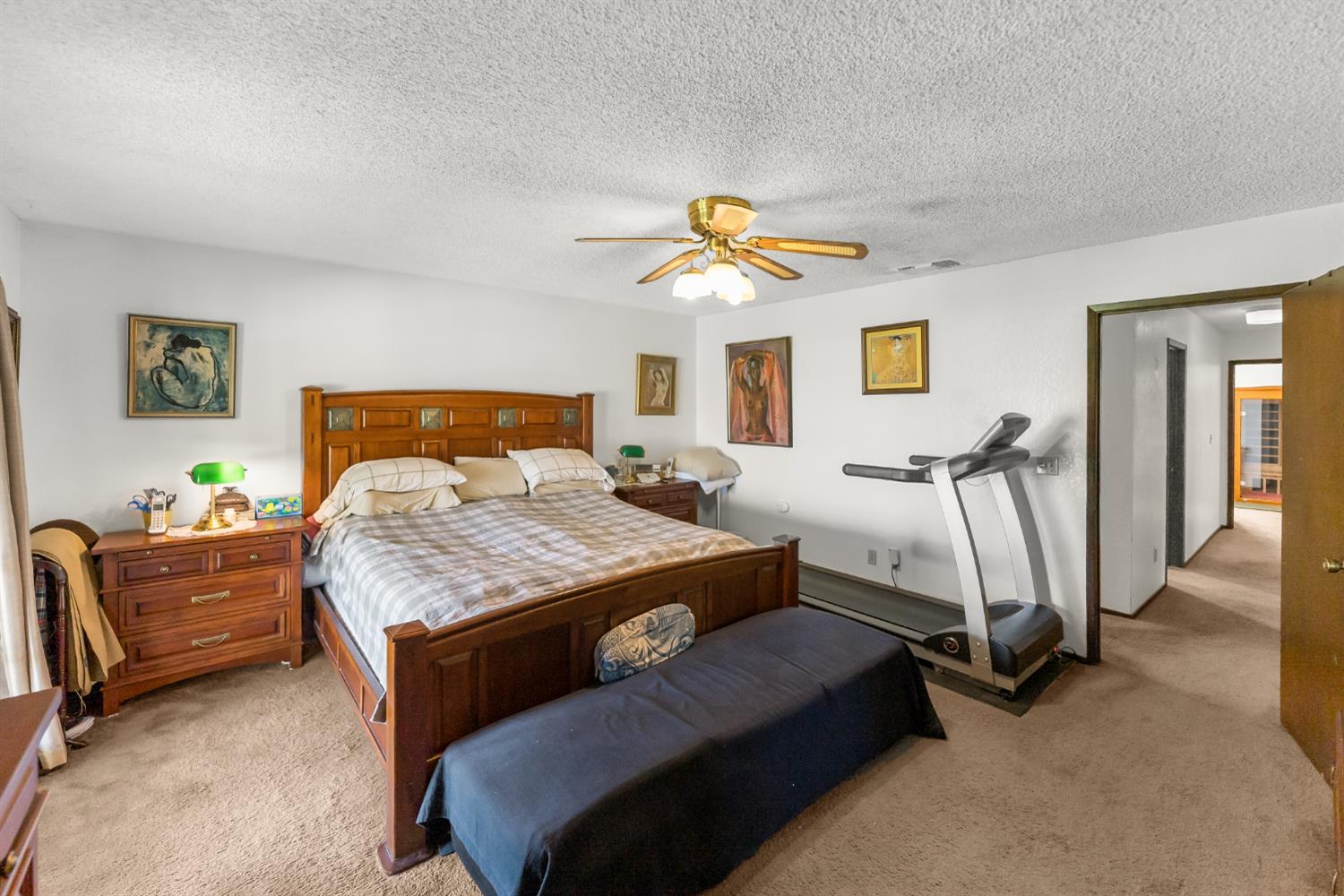 4776 Stetson Road Clovis, CA 93619 - Photo 26 of 49 a bedroom with a bed and a chandelier