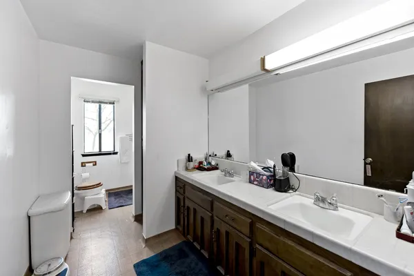 a bathroom with a double vanity sink and a mirror