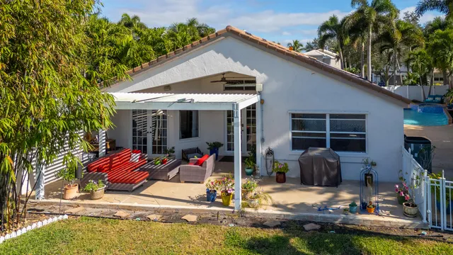an aerial view of house with yard swimming pool and outdoor seating