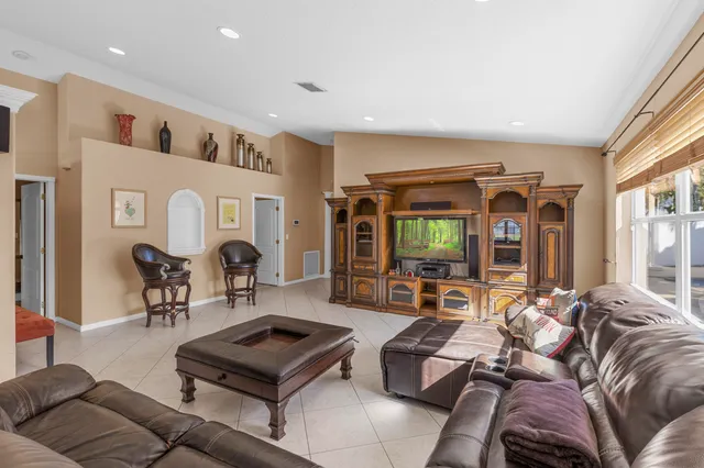 a room with pool table and windows