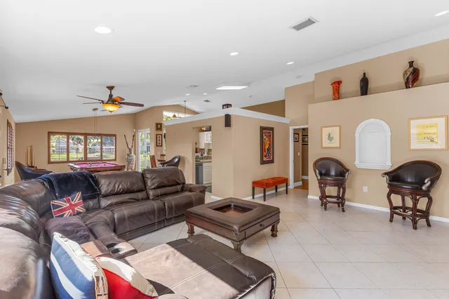a room with pool table and windows