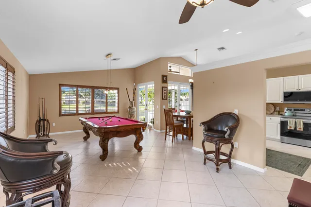 a living room with furniture gym equipment and a large window