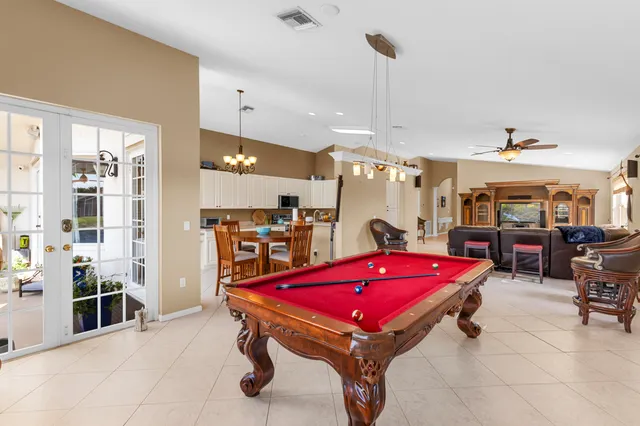 a spacious bathroom with a tub sink and mirror