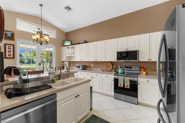 a bathroom with a double vanity sink mirror and shower
