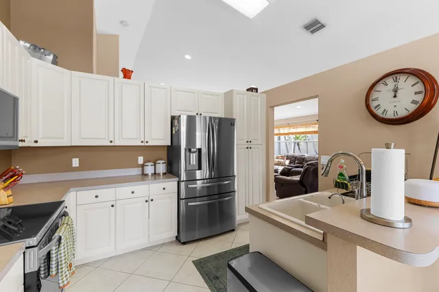 a front view of a house with a garden and yard