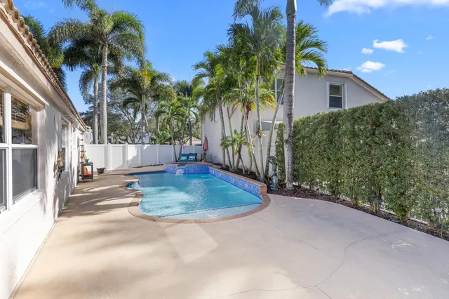 swimming pool with outdoor seating and plants