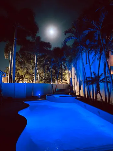 a view of the house with backyard and sitting area