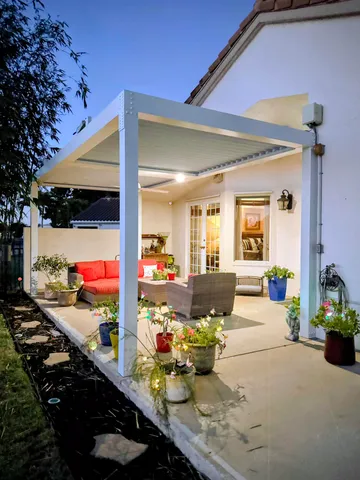 a view of a house with a backyard and a patio
