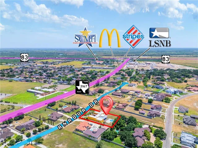 a view of an empty room with wooden floor and windows