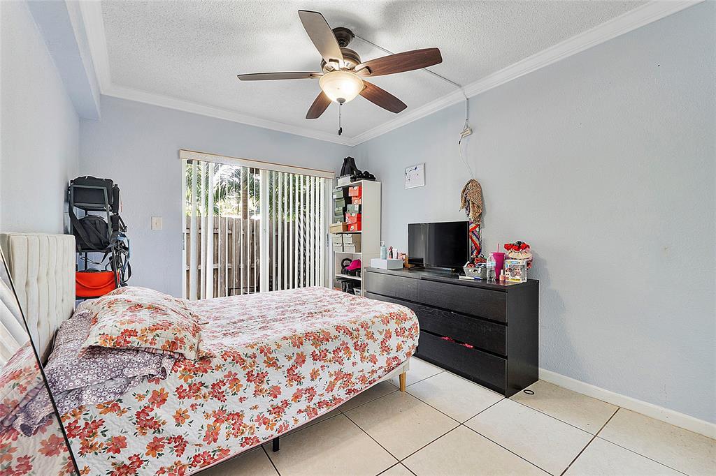 2741 Northeast 8th Avenue, Unit 10 Wilton Manors, FL 33334 - Photo 11 of 28 a bedroom with a bed and a flat screen tv