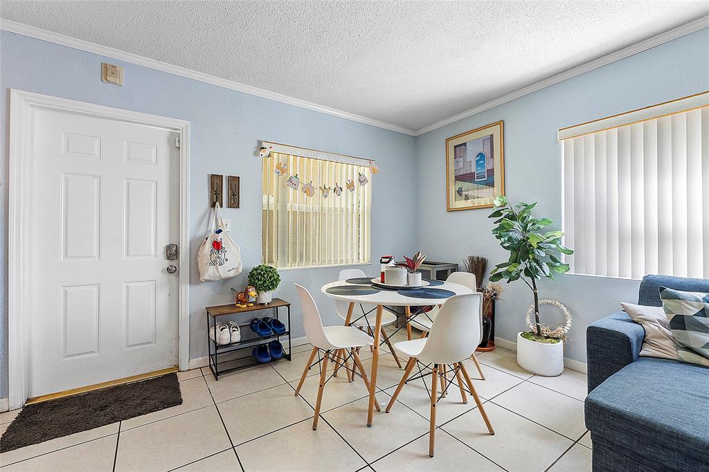 2741 Northeast 8th Avenue, Unit 10 Wilton Manors, FL 33334 - Photo 2 of 28 a living room with furniture and a potted plant
