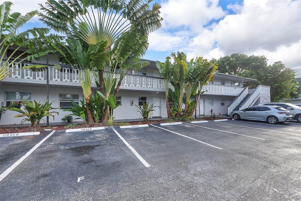 2741 Northeast 8th Avenue, Unit 10 Wilton Manors, FL 33334 - Photo 24 of 28 a view of a car park in front of a house