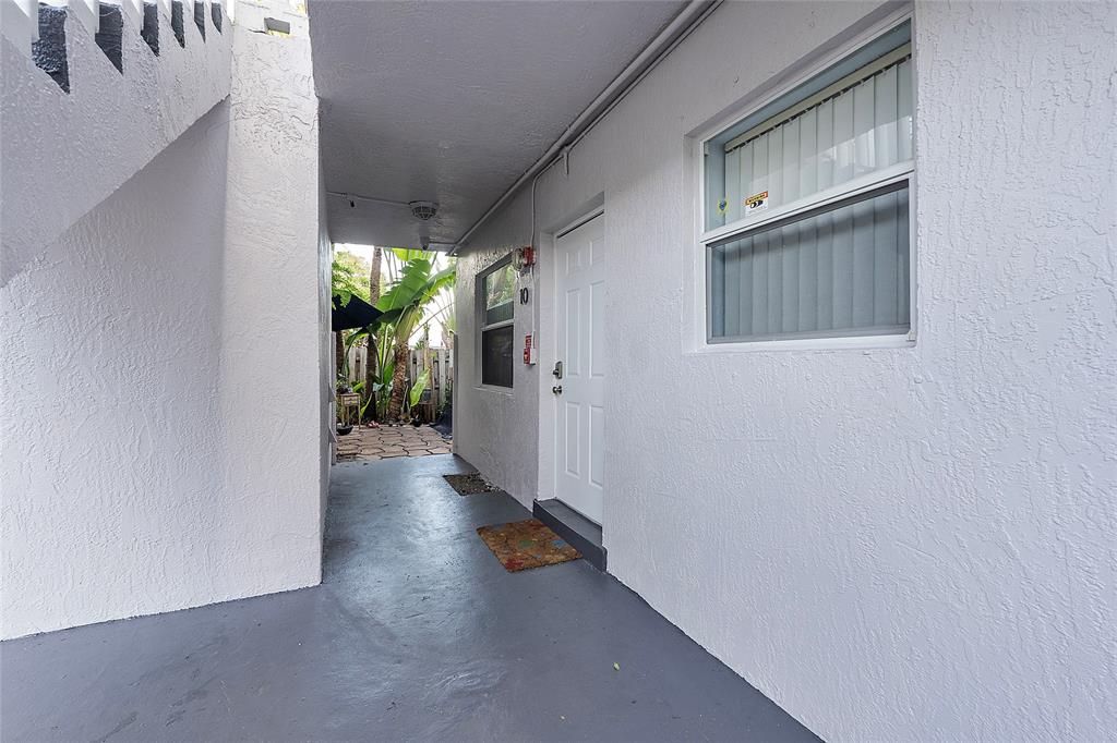 2741 Northeast 8th Avenue, Unit 10 Wilton Manors, FL 33334 - Photo 26 of 28 a view of a house with a hallway