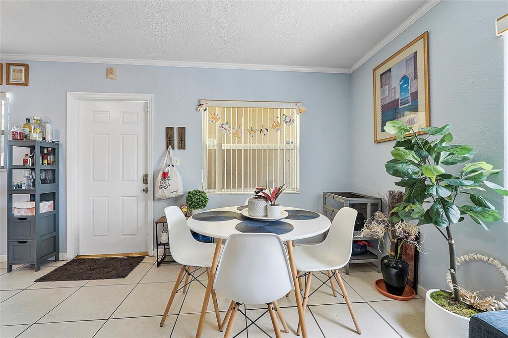 2741 Northeast 8th Avenue, Unit 10 Wilton Manors, FL 33334 - Photo 5 of 28 a dining room with furniture and window