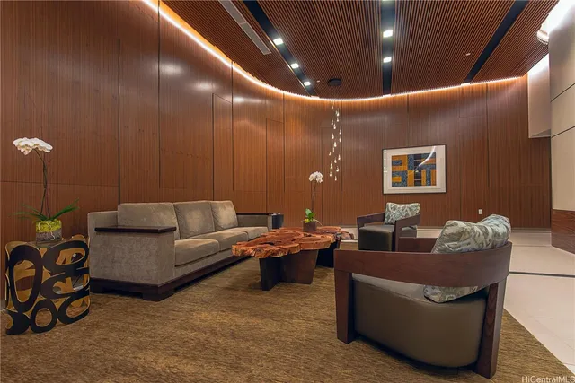 a living room with furniture and a potted plant