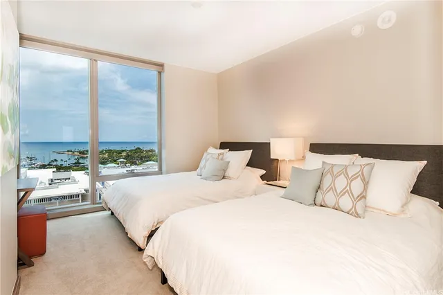 a bedroom with a large bed and a large window