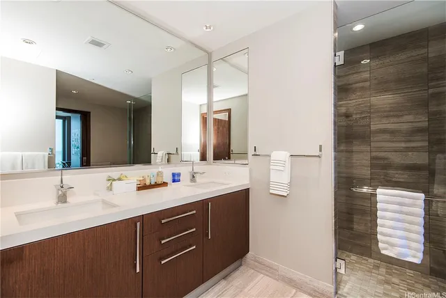 a bathroom with a double vanity sink and mirror