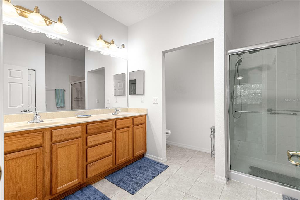 9317 Southwest 94th Loop Ocala, FL 34481 - Photo 21 of 40 a spacious bathroom with a double vanity sink mirror and shower