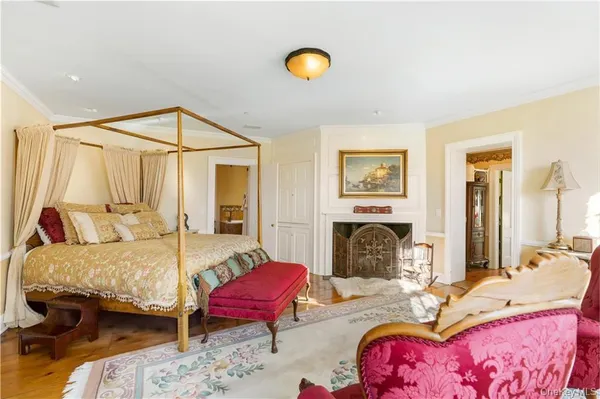 a bedroom with a bed and a fireplace