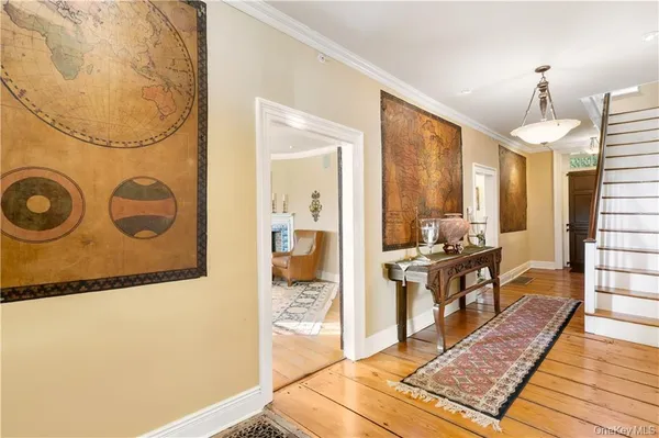 a living room with stainless steel appliances granite countertop furniture and a rug