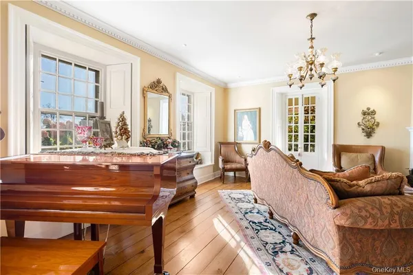 a living room with furniture and a chandelier