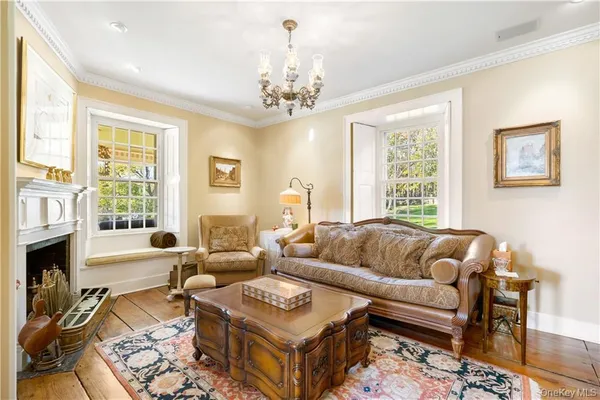 a living room with furniture fireplace and window