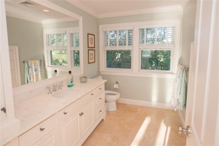 429 Monomoscoy Road Mashpee, MA 02649 - Photo 14 of 26 a spacious bathroom with a double vanity sink a toilet and a window
