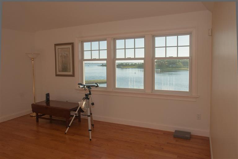 429 Monomoscoy Road Mashpee, MA 02649 - Photo 24 of 26 a room with wooden floor and a window